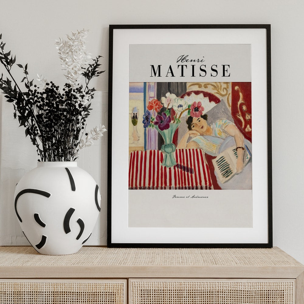 Ausstellungsplakat Henri Matisse mit Frau neben einer Vase mit Anemonen in einem bunten Interieur