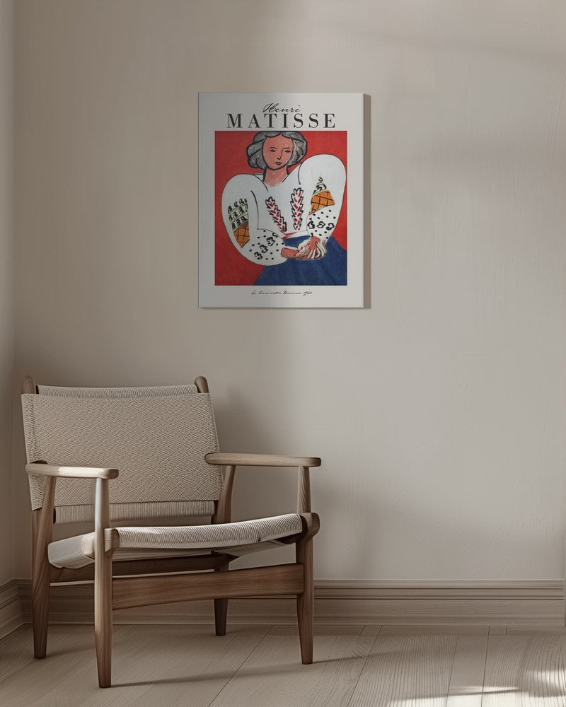 Ausstellungsplakat Henri Matisse mit Frau in bestickter weißer Bluse vor rotem Hintergrund